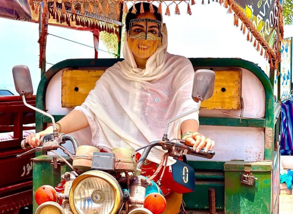 Tourist riding a tuk tuk on Hormuz Island, Iran