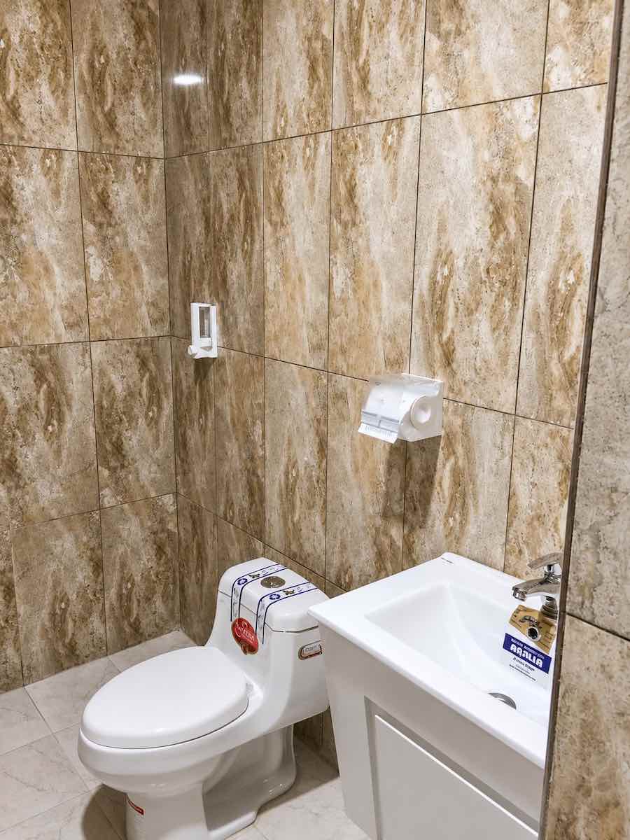 Private Bathroom in Hormuz Family Suite with Toilet, Sink and Modern Tile Finish